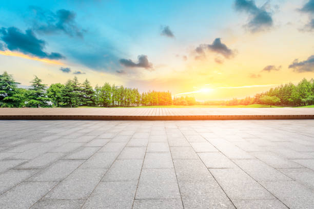 istock Empty square floor and green forest scenery at sunset 1040224634