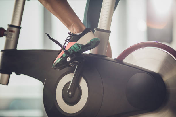 Unrecognizable athletic legs during exercising training in a health club.