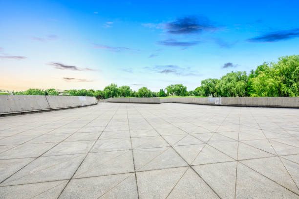 istock Empty square floor and green forest scenery at sunset 1040225908