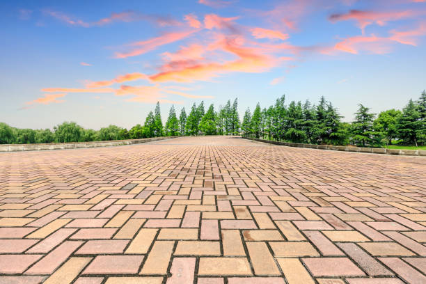 istock Empty square floor and green forest scenery at sunset 1040226342