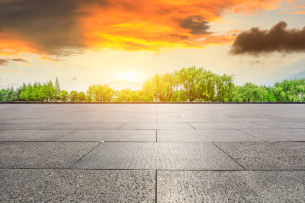 istock Empty square floor and green forest scenery at sunset 1040228848