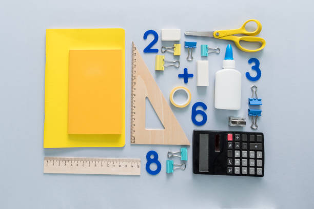 istock School supplies placed in pattern on a grey background. Back to school and education concept. Office supplies as calculator, notebook, rulers, scissors and educational numbers. 1040231780
