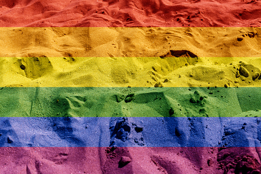 LGBT flag beach sand texture background