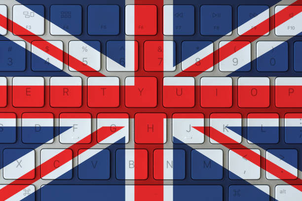 United Kingdom flag and computer keyboard in the background. UK flag