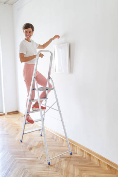 istock Smiling woman decorating showroom 1040250292