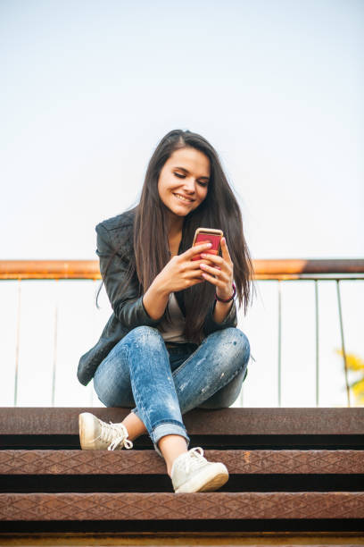 istock Young girl with phone 1040264284