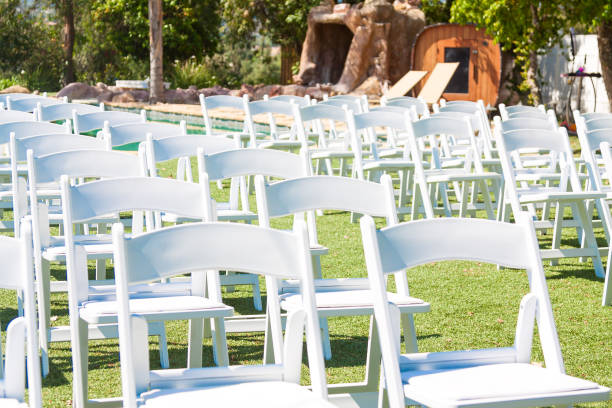 istock White chairs on green grass. Preparing for the outdoor wedding ceremony. 1040270014