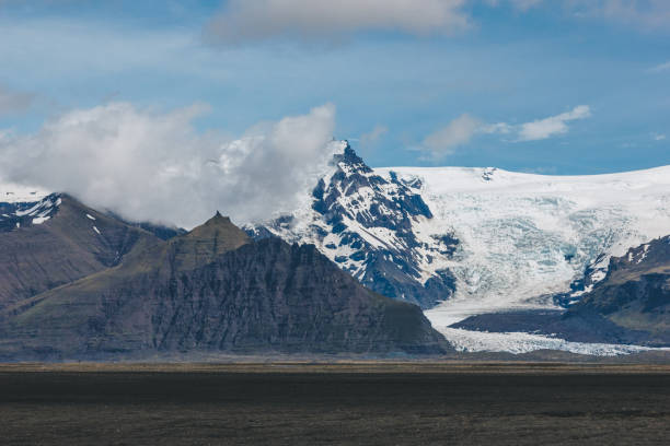 istock beautiful landscape with mountains covered by snow under blue cloudy sky in Iceland 1040270890