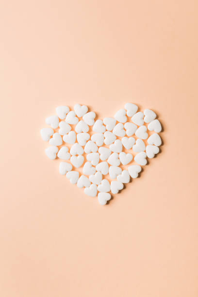 istock Heart shaped pills on a beige background. 1040284706