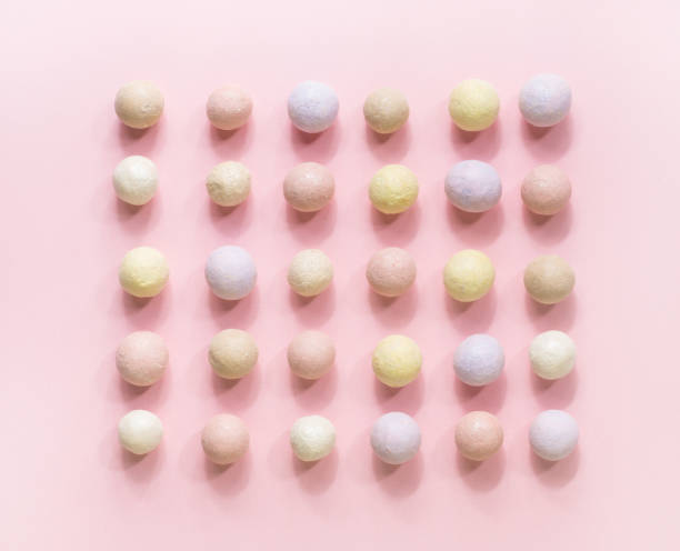 istock Pink blusher balls in a row on a pink background. 1040284722
