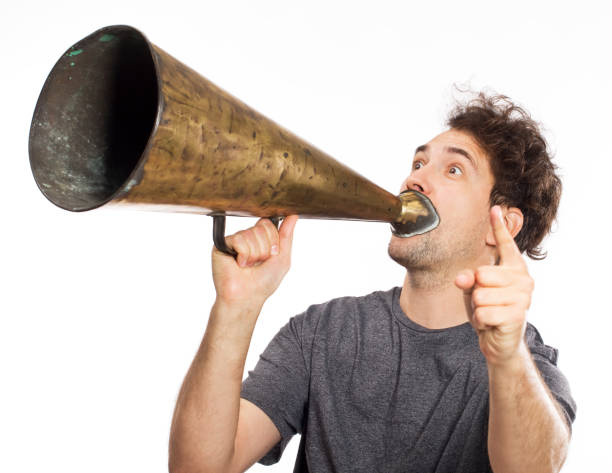 istock Young man yelling into a retro megaphone 1040285156