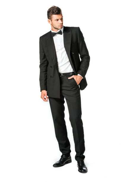 istock handsome young man in black suit looking away isolated on white 1040285668