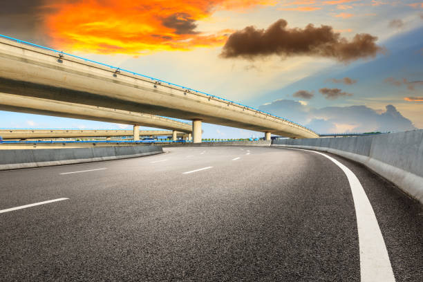 istock Asphalt road and modern bridge building scenery at sunset 1040285898