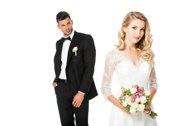 istock beautiful young bride with bouquet and groom isolated on white 1040288740