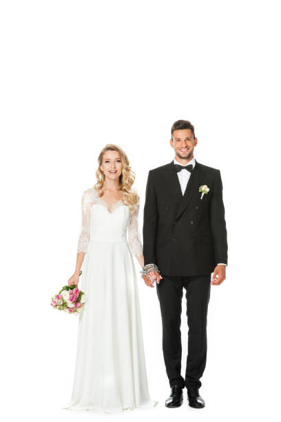 istock happy young bride and groom holding hands and looking at camera isolated on white 1040289178