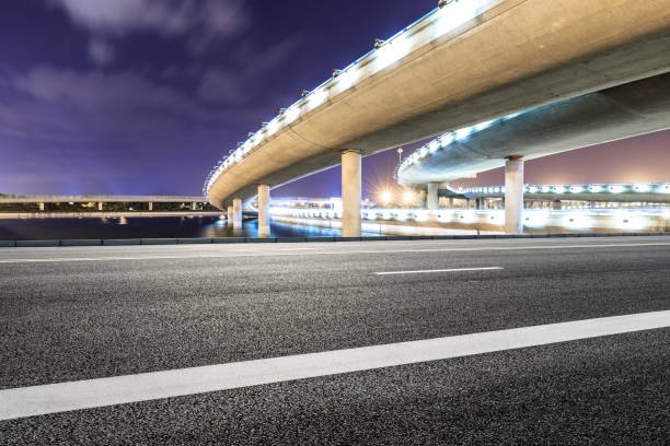 istock Asphalt road and modern bridge building scenery at night 1040289618