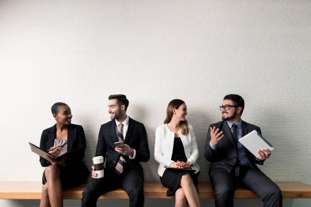istock Group of business executives sitting on bench 1040294300