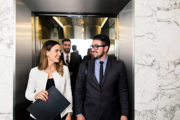 istock Business executives walking out of elevator 1040294328