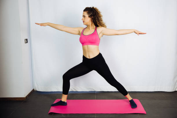 istock Curly Brunette Exercising at the Home 1040294540