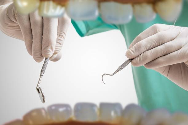 istock View from mouth on dentist with dental instruments. 1040300558