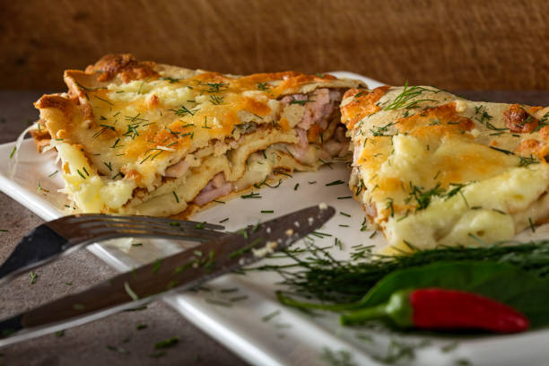 istock Baked pancake stuffed with chease, cream and ham on the white plate 1040302870
