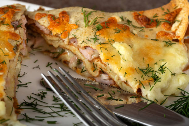 istock Baked pancake stuffed with chease, cream and ham on the white plate 1040302904
