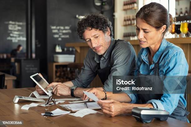 Staff Calculating Restaurant Bill Stock Photo - Download Image Now - Small Business, Owner, Business