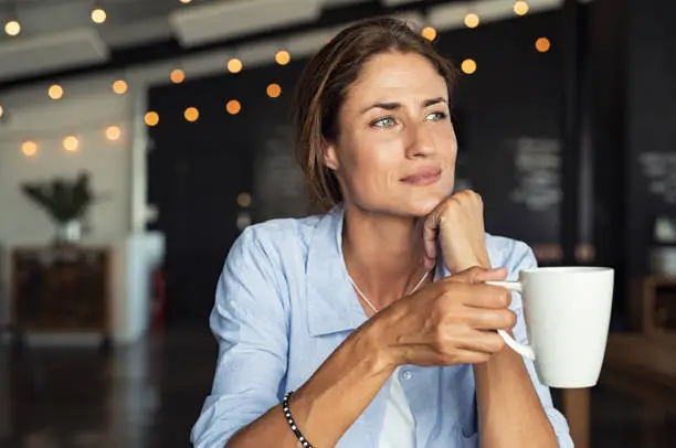 Photo of Mature woman drinking coffee