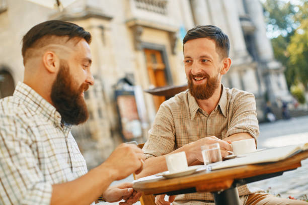 istock two men drink coffee at a cafe 1040304774