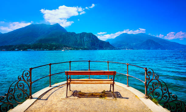 Bench on lakefront in Como Lake landscape. Bellagio Italy Europe