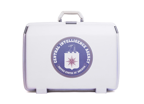 Used plastic suitcase with stains and scratches, printed with flag - CIA