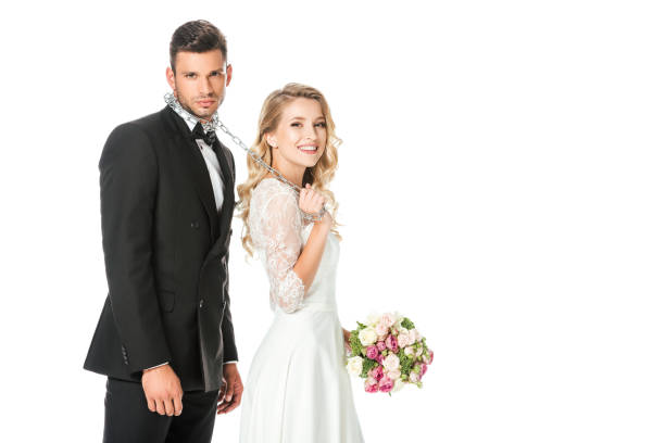 istock happy young bride with chain and leashed groom looking at camera isolated on white 1040307874