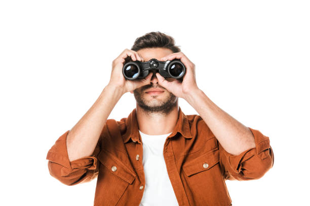 istock handsome young man looking at camera with binoculars isolated on white 1040308288