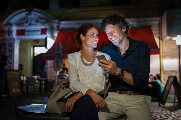 istock Happy mature couple using smartphone at night 1040308530
