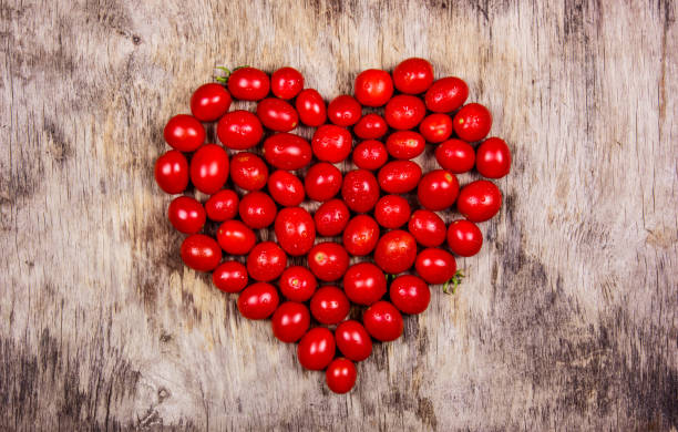 istock Cherry tomatoes in heart shape. Red heart from tomatoes. 1040309656