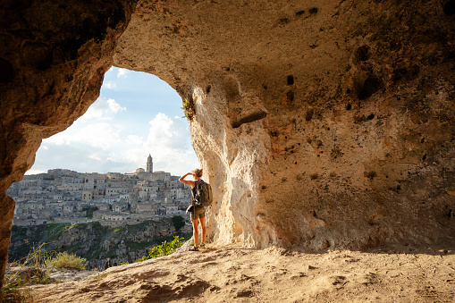 Woman looking at view from a cave of Matera, Basilicata, Italy