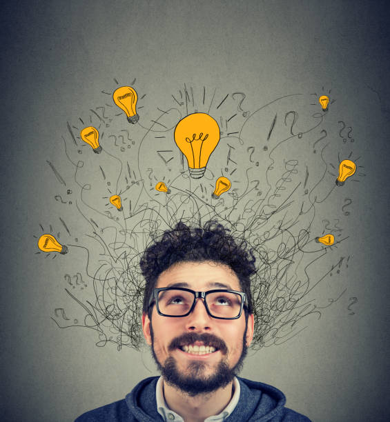 istock Excited man looking up at many ideas light bulbs above head 1040319876