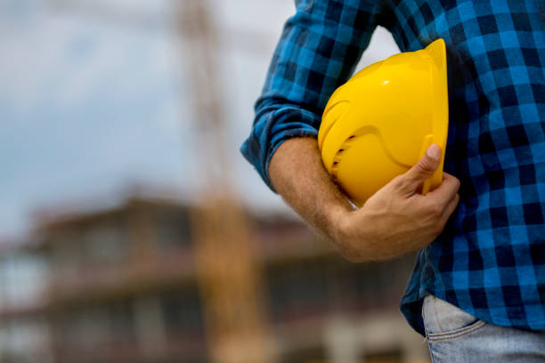 istock Close-up of architect holding hardhat 1040320466