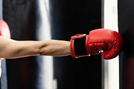 Mature adult woman training at boxing gym