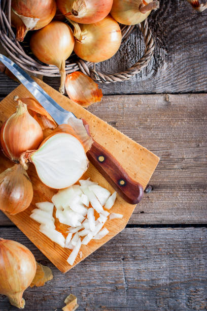 istock Finely chopped onions on a wooden table, selective focus 1040324086