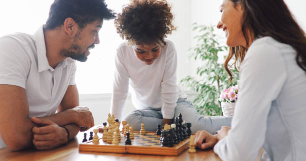istock Happy family playing chess together at home 1040324382