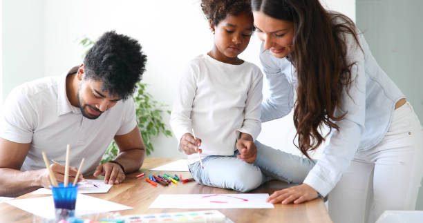 istock Mother and father drawing together with their child 1040324448
