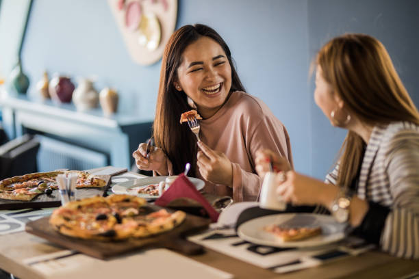 istock Happy Asian women communicating on a lunch in a restaurant. 1040329318