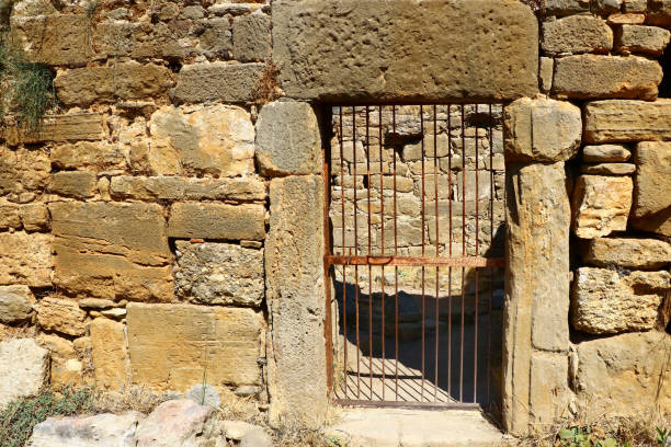 istock old antique stone wall with rusty latticed door 1040334900