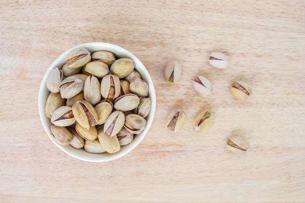 istock pistachio in bowl on wooden background. 1040335136