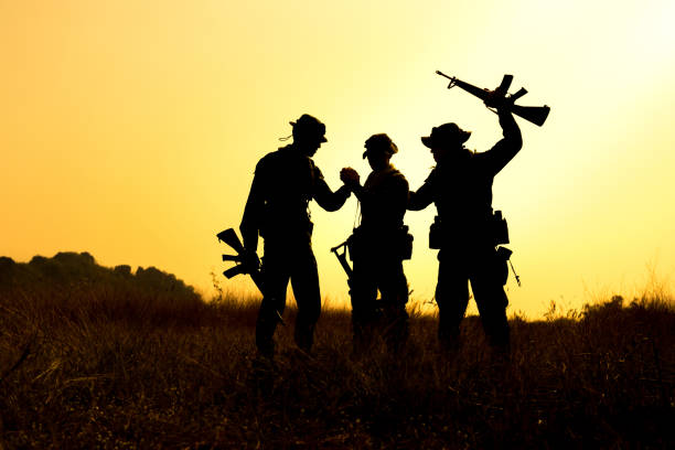 istock Military soldier holding weapons overhead after get victory. 1040337968