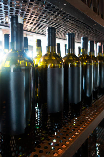 Wine bottles on shelves at a winery