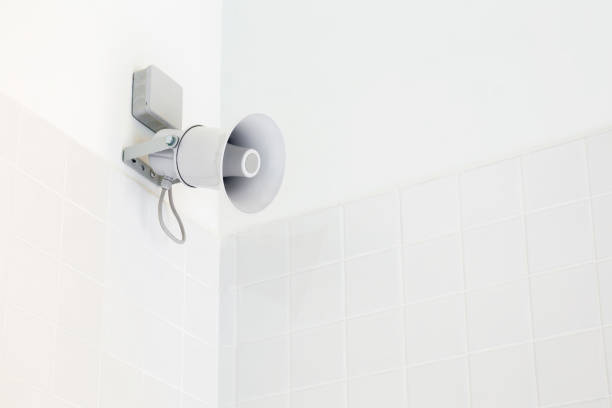 istock Megaphone on the white wall in the corner. Empty place for text. 1040343042