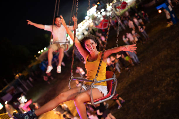 istock Happy young couple on carousel in amusement park 1040359800