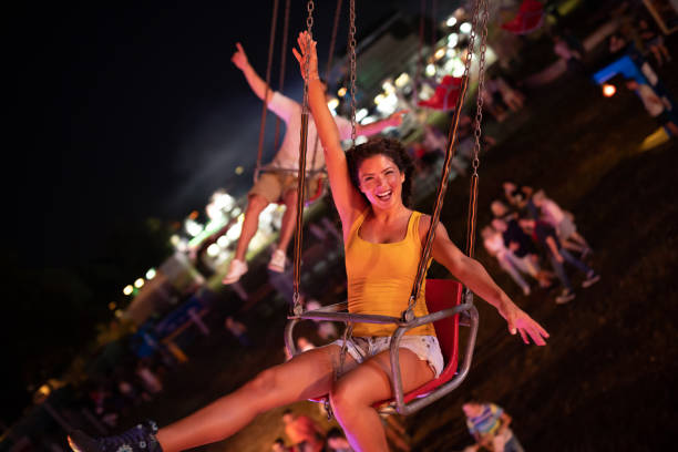 istock Happy young couple on carousel in amusement park 1040359908